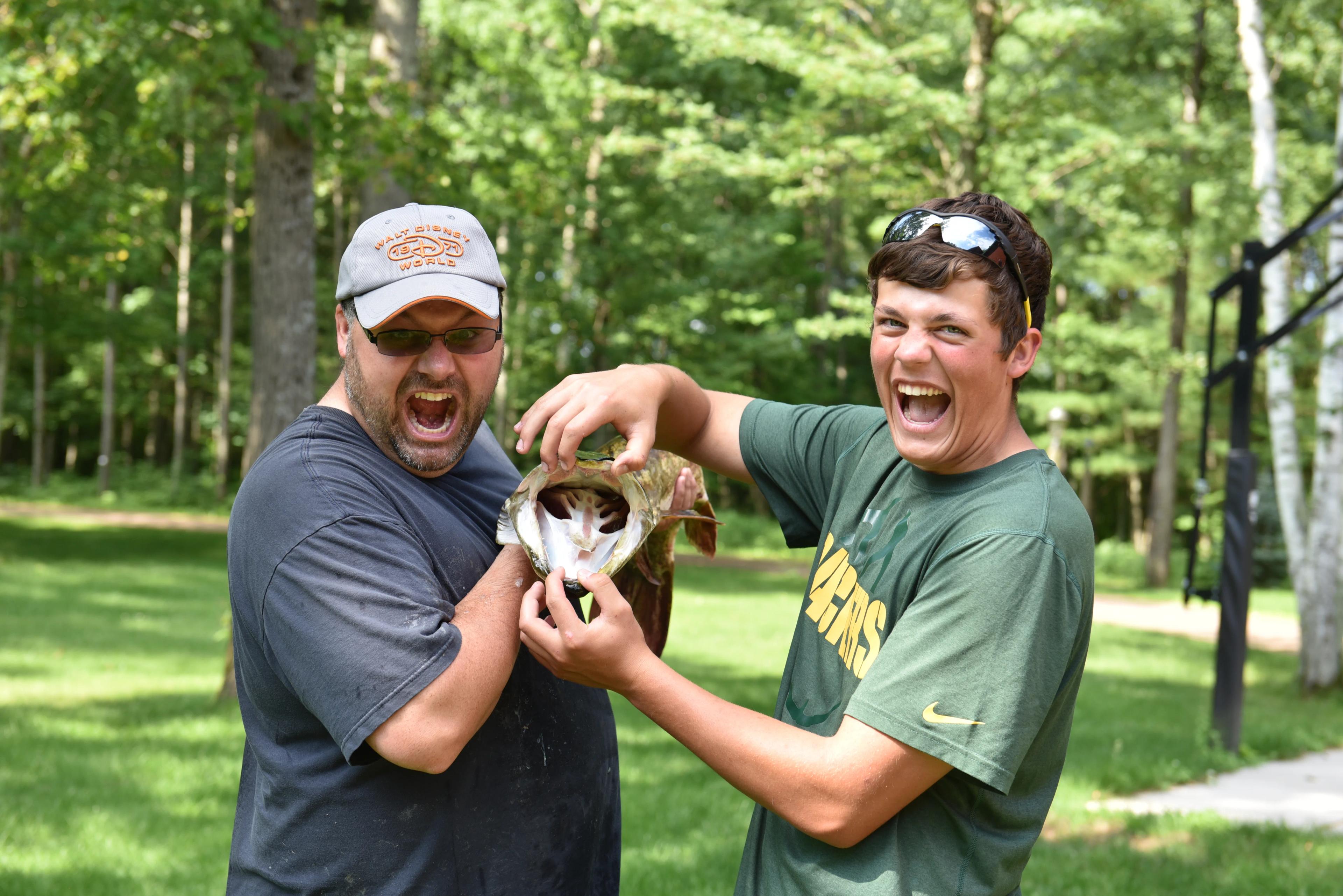 Dr. Carroll and his son showing off a catch on the water near Spooner, WI
